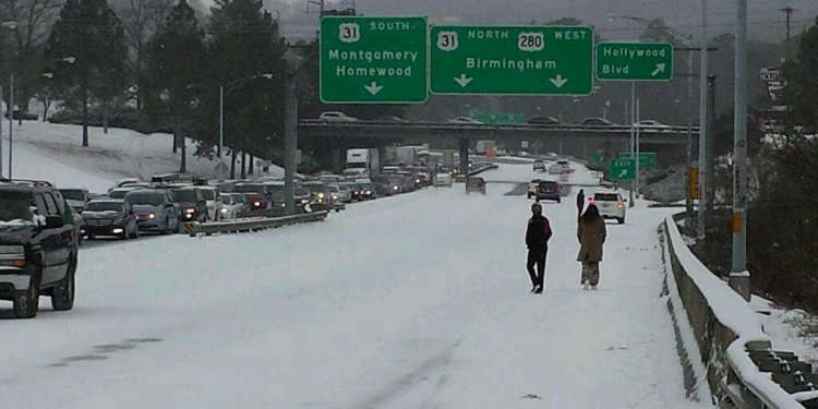 People walk along Highway 280